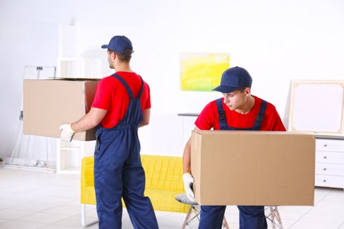 Furniture pick-up service helping with sofa removal in a Woodside Park home