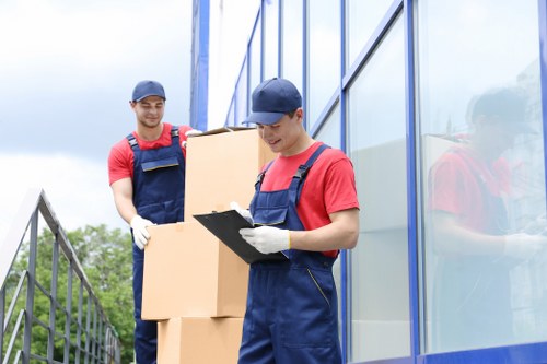 Team loading a van safely with protective equipment